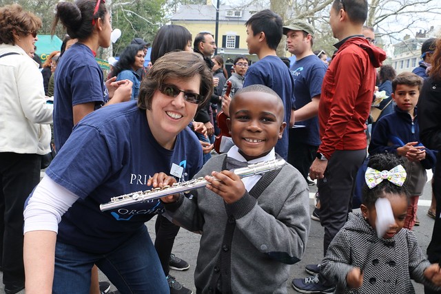Happy young flutist with PSO staff member