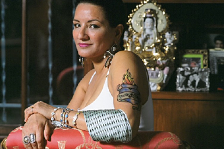 Sandra Cisneros in red chair