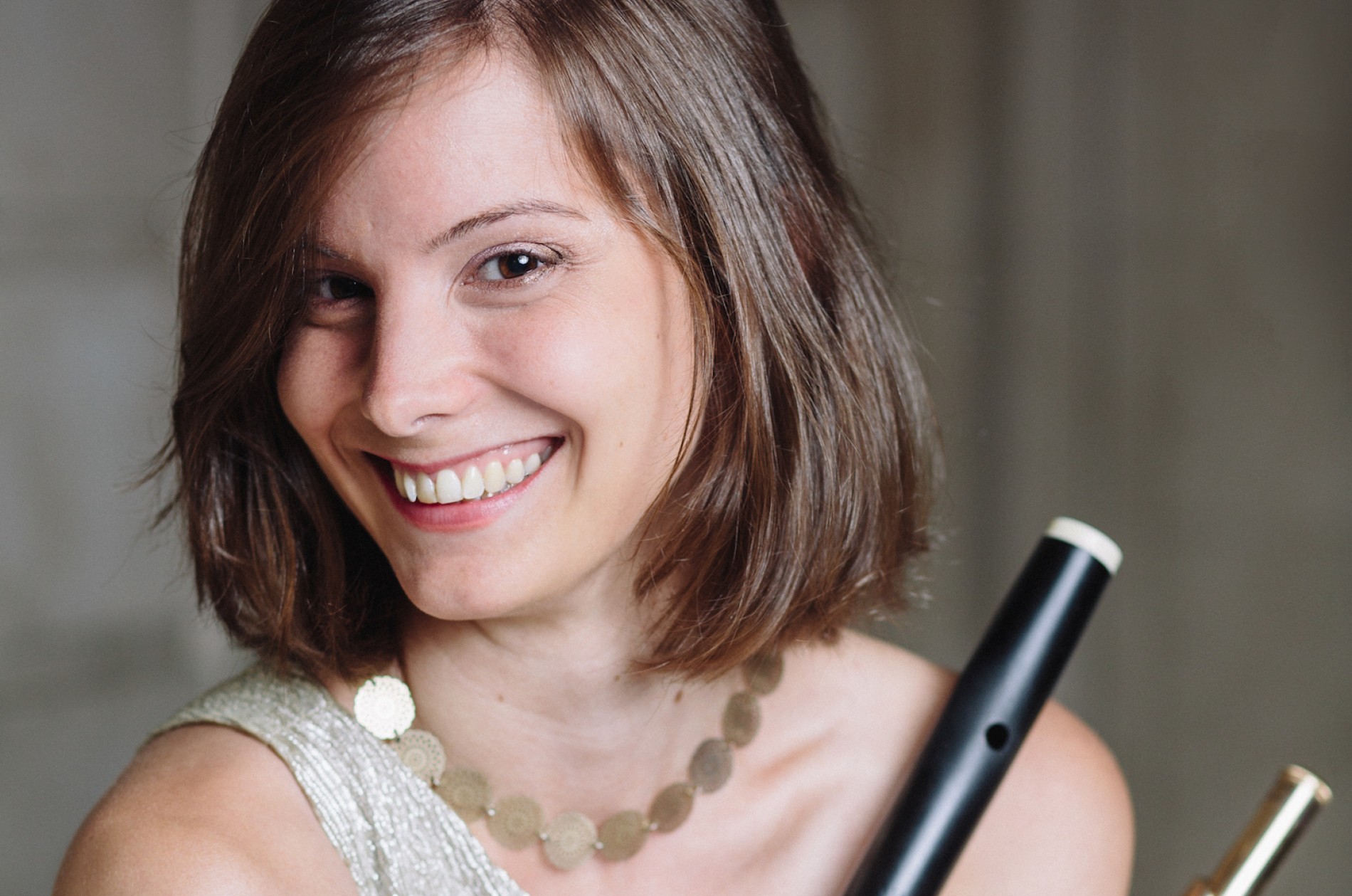 Arrayed in gold, Melanie Williams holds early and modern flutes