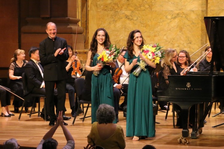 Rossen Milanov and the pianists Christine and Michelle Naughton bowing at the end of their performance.