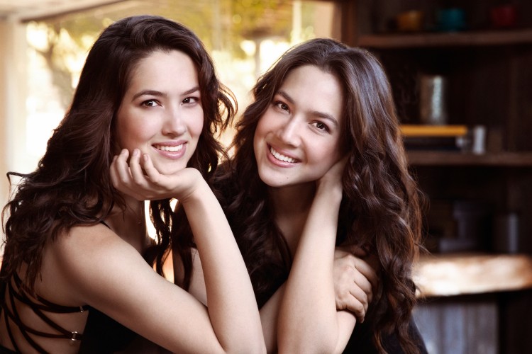 Twin sisters Christina and Michelle Naughton smiling together