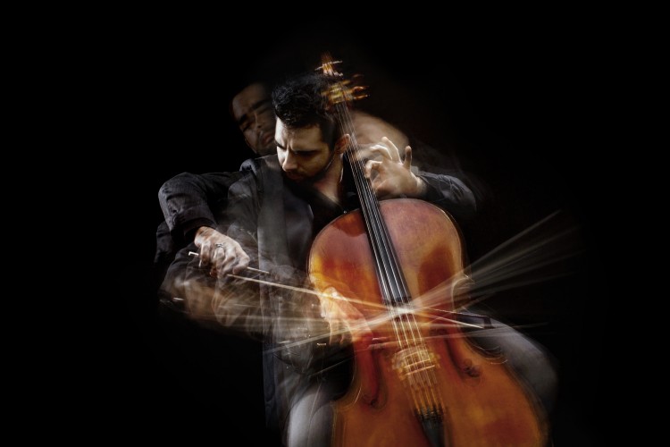 Pablo Ferrández playing the cello against black background