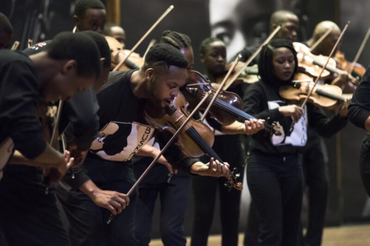 Violinists in the Buskaid Soweto String Ensemble performing