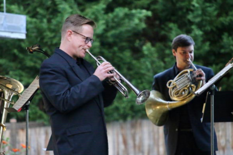 Jerry Bryant, trumpet, and Jonathan Clark, horn, perform outside
