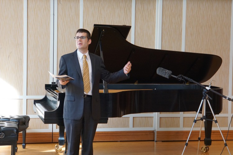 Festival Director Gregory J. Geehern next to a piano