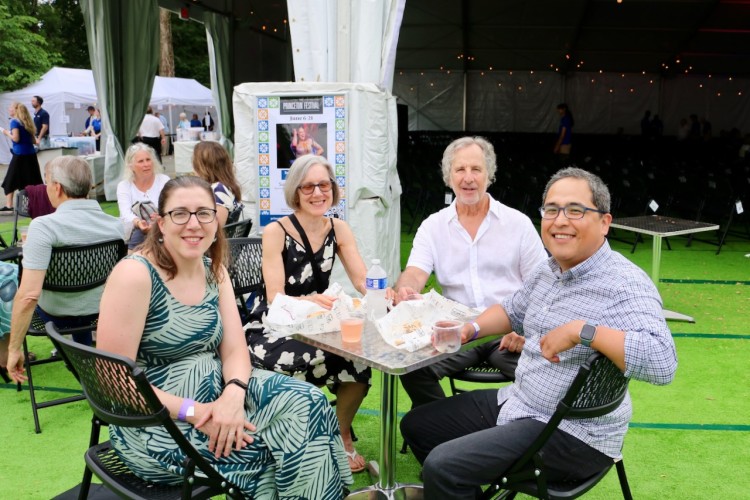 Four table-top picnickers outside the Princeton Festival performance pavilion.