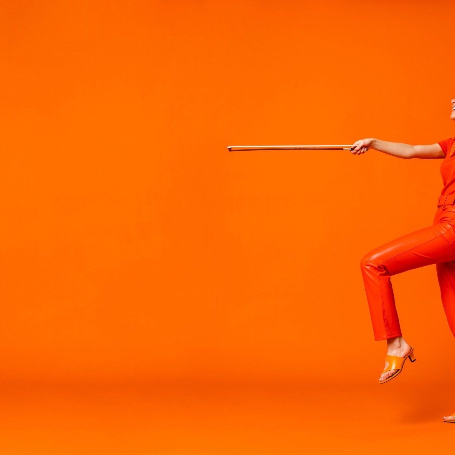 Aubree Oliverson, violin – monochromatic orange publicity shot