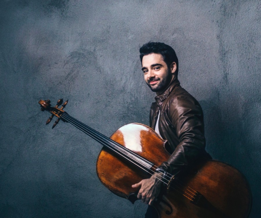 Pablo Ferrandez holding his cello against his side