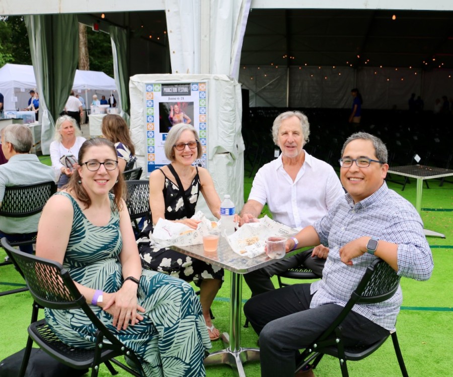 Picnickers at a table outside the Princeton Festival performance pavilion