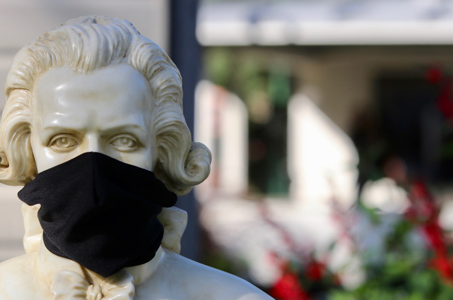Mozart bust wearing black mask