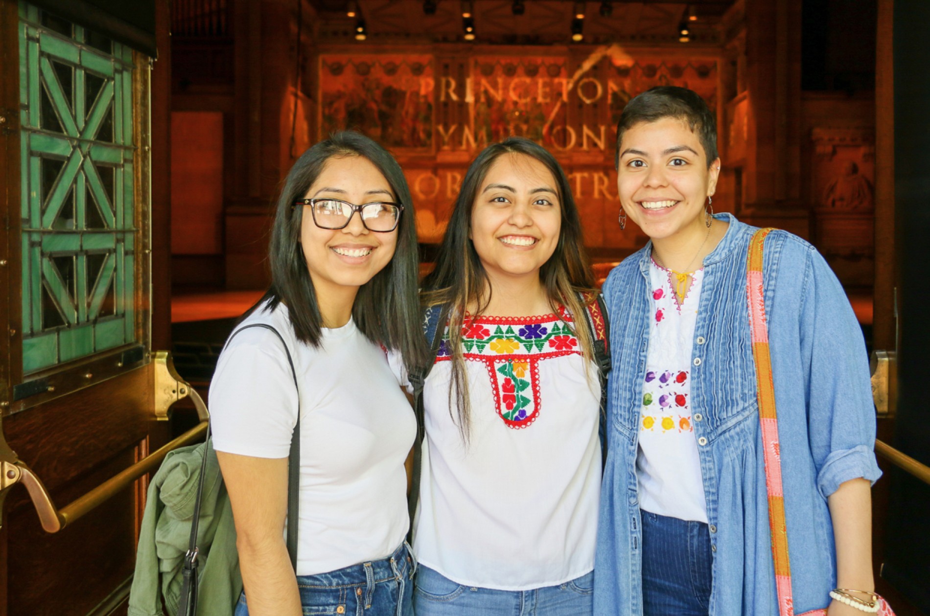 Three girls standing at the entrance to Richardson Auditorium