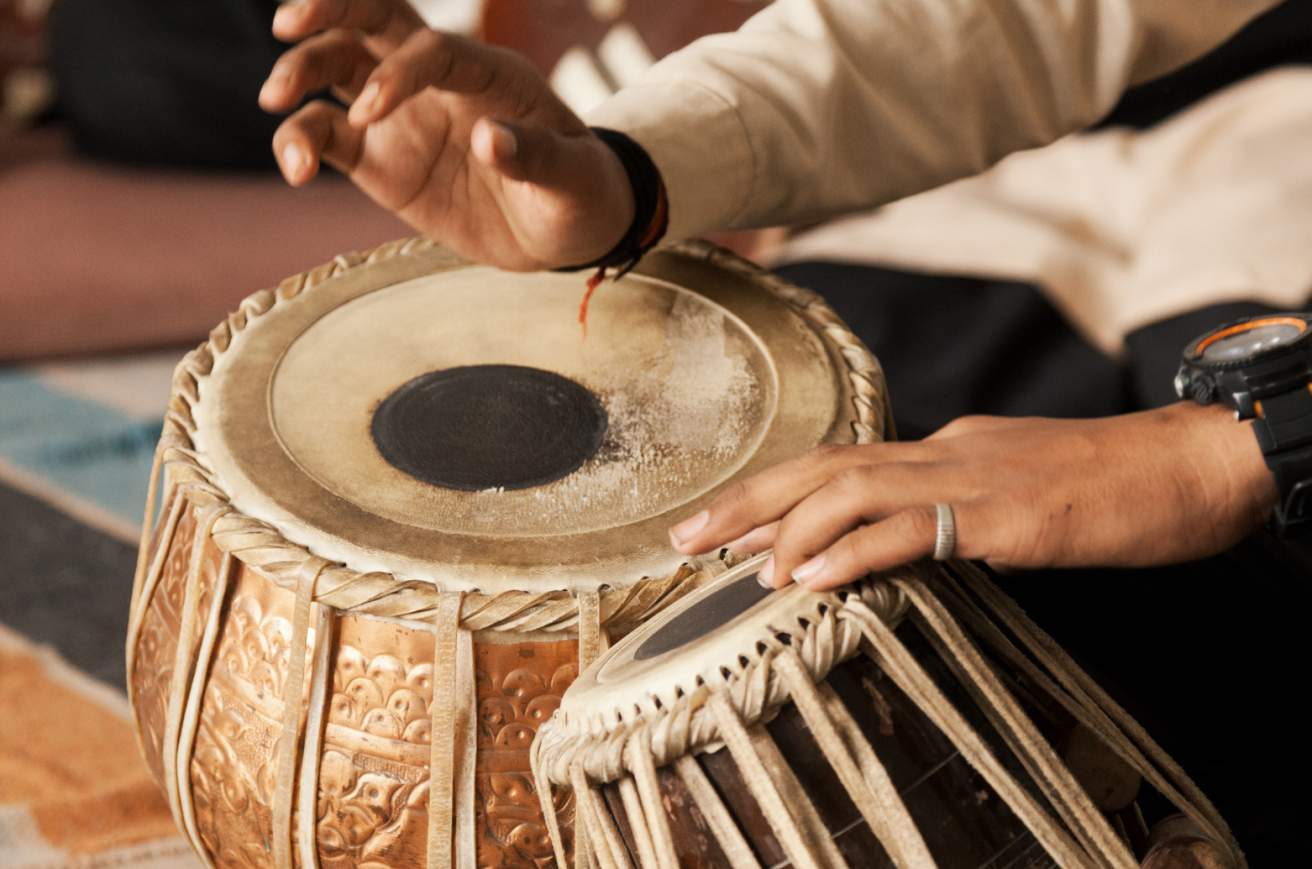 tabla percussion instrument being played with two hands visible