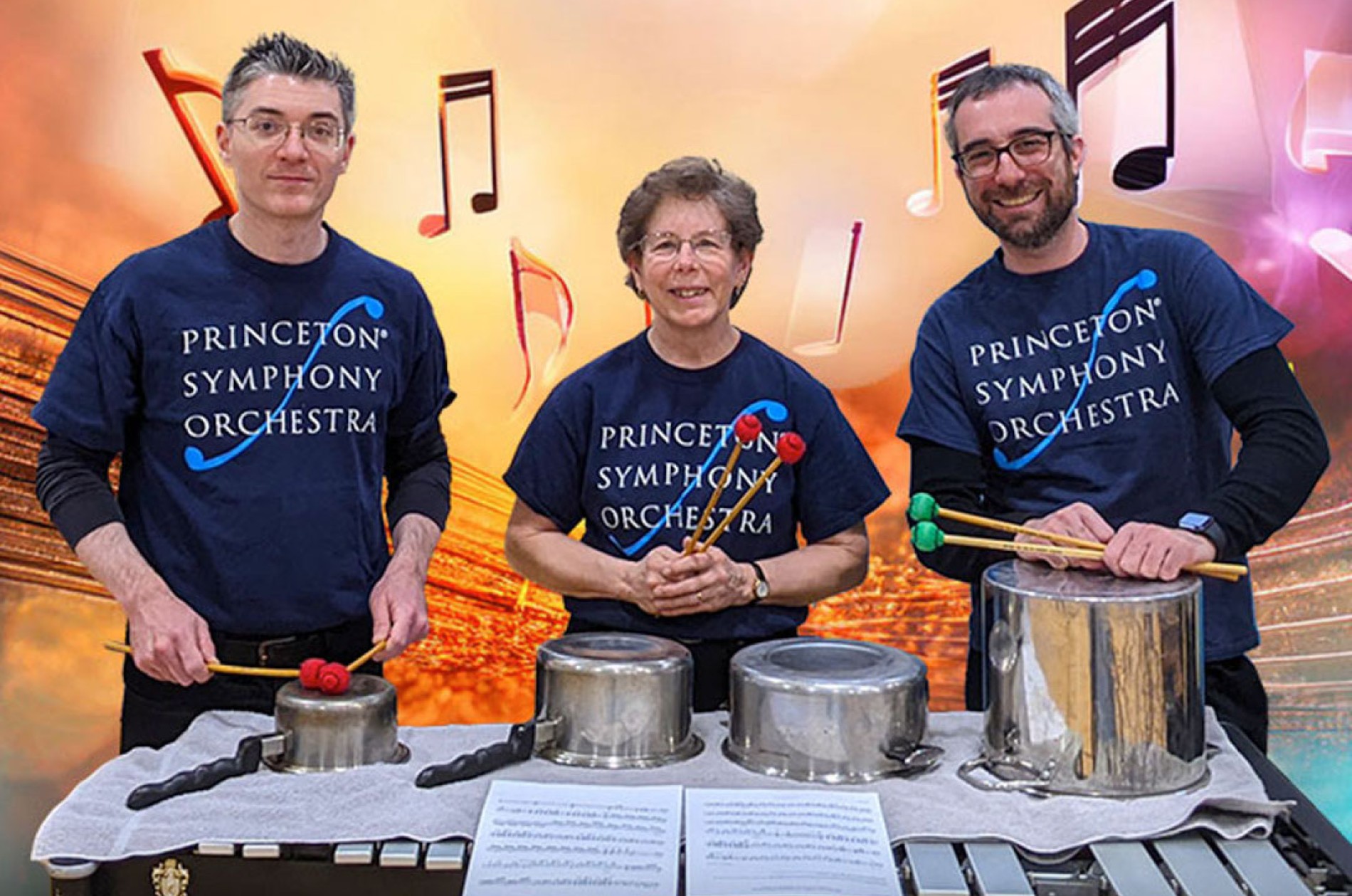 PSO BRAVO! Percussion musicians next to percussion instruments, wearing t-shirts that read: Princeton Symphony Orchestra