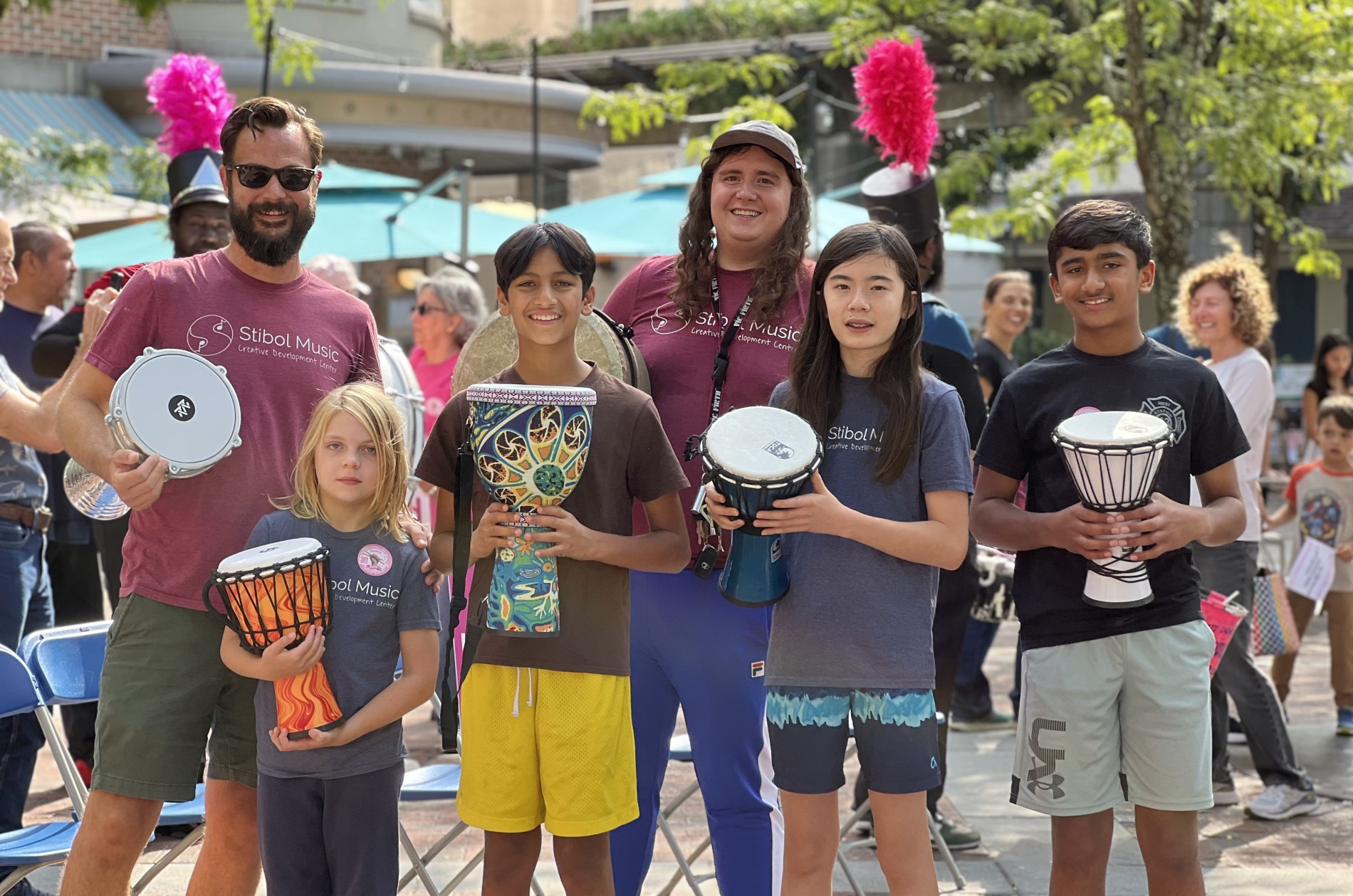 drum circle participants holding hand percussion