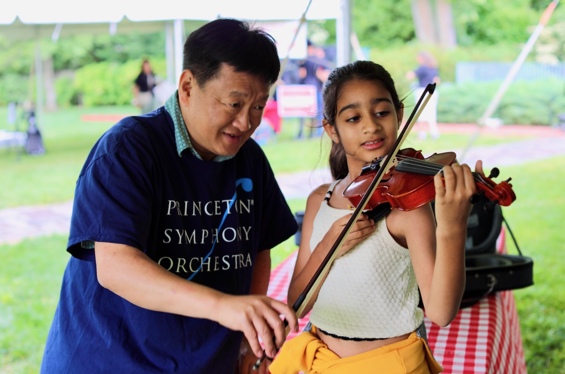 trying violin at the instrument petting zoo
